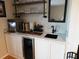 Basement wet bar with white cabinets and marble countertop at 265 Sea Cloud Cir, Edisto Island, SC 29438