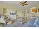 Bright living room with comfy seating, TV, and access to dining area at 2393 Folly Road # 1G, Folly Beach, SC 29439