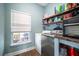 Bright laundry room, featuring washer, dryer, and ample storage shelving at 417 Crystal Oaks Ln, Moncks Corner, SC 29461