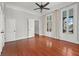 Hardwood floors, French doors, and neutral walls in this bedroom at 52 Laurens St, Charleston, SC 29401