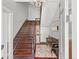 Inviting entryway with hardwood floors, antique bench, and grand staircase at 52 Laurens St, Charleston, SC 29401