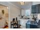 Galley kitchen with patterned backsplash and small dining area at 52 Laurens St, Charleston, SC 29401