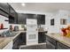 Well-equipped kitchen with dark cabinets, white appliances, and ample counter space at 7928 Shadow Oak Dr, North Charleston, SC 29406