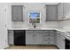 Modern kitchen with gray cabinets, stainless steel appliances and quartz countertops at 2460 Deer Ridge Ln # 1, North Charleston, SC 29406