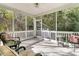 Relaxing screened porch with wicker furniture and wooded views at 2460 Deer Ridge Ln # 1, North Charleston, SC 29406