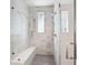 Spa-like shower with marble tile, glass enclosure, and built-in seat at 64 Grand Pavilion Blvd, Isle of Palms, SC 29451