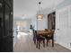 Bright dining area with a wood table and four chairs, and view into living room at 1755 Central Park Rd # 6109, Charleston, SC 29412