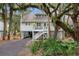 Elevated home with a wrap around porch and lush landscaping at 534 Cobby Creek Ln, Seabrook Island, SC 29455