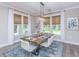 Spacious dining area with a large wood table and blue rug at 263 Darby Meadow Ln, Ridgeville, SC 29472