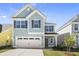 Two-story home with gray siding and attached garage at 353 Hillman Trail Dr, Moncks Corner, SC 29461