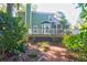 Green house exterior with deck and surrounding trees at 794 Hunt Club Run, Charleston, SC 29414