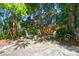 Relaxing backyard with fire pit, surrounded by trees and greenery at 794 Hunt Club Run, Charleston, SC 29414