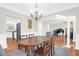 Elegant dining room features a large wood table, chandelier, and views into the kitchen and living room at 794 Hunt Club Run, Charleston, SC 29414
