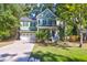 Green house with white two-car garage and landscaping at 794 Hunt Club Run, Charleston, SC 29414