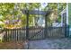 Charming backyard with wooden gate and arbor leading to a patio at 794 Hunt Club Run, Charleston, SC 29414