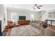 Bright living room boasts hardwood floors, a cozy seating area, and large windows at 794 Hunt Club Run, Charleston, SC 29414
