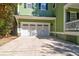Three-car garage with white doors and decorative windows at 794 Hunt Club Run, Charleston, SC 29414