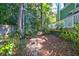 Landscaped backyard with stone pathway, wooden fence, and lush greenery at 794 Hunt Club Run, Charleston, SC 29414