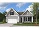One-story gray home with white garage door and landscaping at 342 Hillman Trail Dr, Moncks Corner, SC 29461