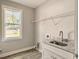 Laundry Room with sink, shelving, and window at 4566 Durant Ave, North Charleston, SC 29405