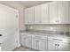 Laundry room with white cabinets and granite countertop at 4566 Durant Ave, North Charleston, SC 29405
