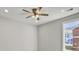 Bedroom with grey walls, window, and ceiling fan at 4566 Durant Ave, North Charleston, SC 29405