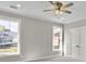 Bright bedroom with two windows, ceiling fan, and grey carpet at 4566 Durant Ave, North Charleston, SC 29405