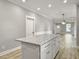 Kitchen island with granite countertop and white cabinets at 4566 Durant Ave, North Charleston, SC 29405