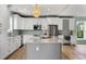 Open kitchen boasting white cabinets, a center island, and stainless steel appliances at 1008 Mariners Cay Dr, Folly Beach, SC 29439