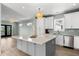 Bright kitchen featuring white cabinets, a large island, and stainless steel appliances at 1008 Mariners Cay Dr, Folly Beach, SC 29439