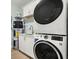 Laundry room with white cabinets, washer, and dryer at 1008 Mariners Cay Dr, Folly Beach, SC 29439