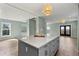 Modern kitchen with gray island, white cabinets, and stainless steel appliances at 1008 Mariners Cay Dr, Folly Beach, SC 29439