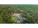 Aerial view of new houses under construction in a wooded area with a pond at 186 E Pinckney St, Lincolnville, SC 29485