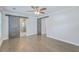 Bedroom with hardwood floors, barn doors to bathroom, and ceiling fan at 1713 Sparkleberry Ln, Johns Island, SC 29455