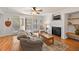 Bright living room with hardwood floors, fireplace, and access to a deck at 413 E Indian Ave, Folly Beach, SC 29439