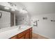 Bathroom with wood vanity, large mirror and tile floor at 413 E Indian Ave, Folly Beach, SC 29439