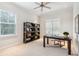 Bright home office with built-in shelving and hardwood floors at 5250 Timber Race Crse, Hollywood, SC 29449