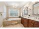 Bathroom with double vanity and a soaking tub at 5250 Timber Race Crse, Hollywood, SC 29449