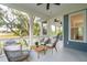 Relaxing screened porch with wooden floors, wicker chairs, and views of the backyard at 5250 Timber Race Crse, Hollywood, SC 29449
