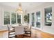Bright dining room with hardwood floors, chandelier, and French doors at 5250 Timber Race Crse, Hollywood, SC 29449