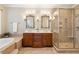 Elegant bathroom with double sinks, soaking tub, and a walk-in shower at 5250 Timber Race Crse, Hollywood, SC 29449