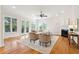 Light-filled living room with hardwood floors, fireplace, and ample seating at 5250 Timber Race Crse, Hollywood, SC 29449