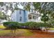Two-story light blue house with white trim and a wrap-around porch at 5250 Timber Race Crse, Hollywood, SC 29449
