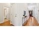 Bright hallway with hardwood floors, bathroom access, and storage at 5250 Timber Race Crse, Hollywood, SC 29449