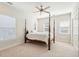 Charming bedroom with a wooden four-poster bed, carpet flooring, and two windows with blinds at 5250 Timber Race Crse, Hollywood, SC 29449