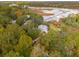 Aerial view of a light blue house nestled in the woods near the water at 5250 Timber Race Crse, Hollywood, SC 29449