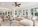 Open living room with hardwood floors, sectional sofa, and large windows at 5250 Timber Race Crse, Hollywood, SC 29449