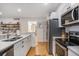 Modern kitchen with stainless steel appliances and white cabinetry at 93 Mariners Cay Drive, Folly Beach, SC 29439