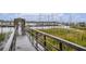 Wooden dock leads to the marina with many boats at 93 Mariners Cay Drive, Folly Beach, SC 29439