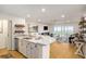 Open concept kitchen with white cabinets, quartz countertops and ocean view at 93 Mariners Cay Drive, Folly Beach, SC 29439